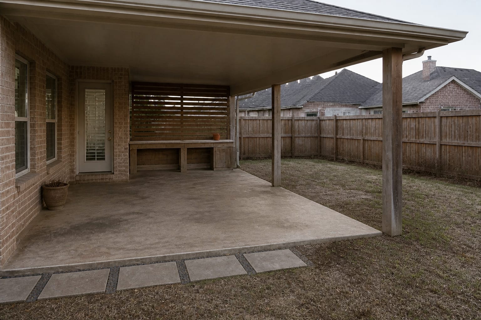 underused covered backyard patio before AI outdoor redesign
