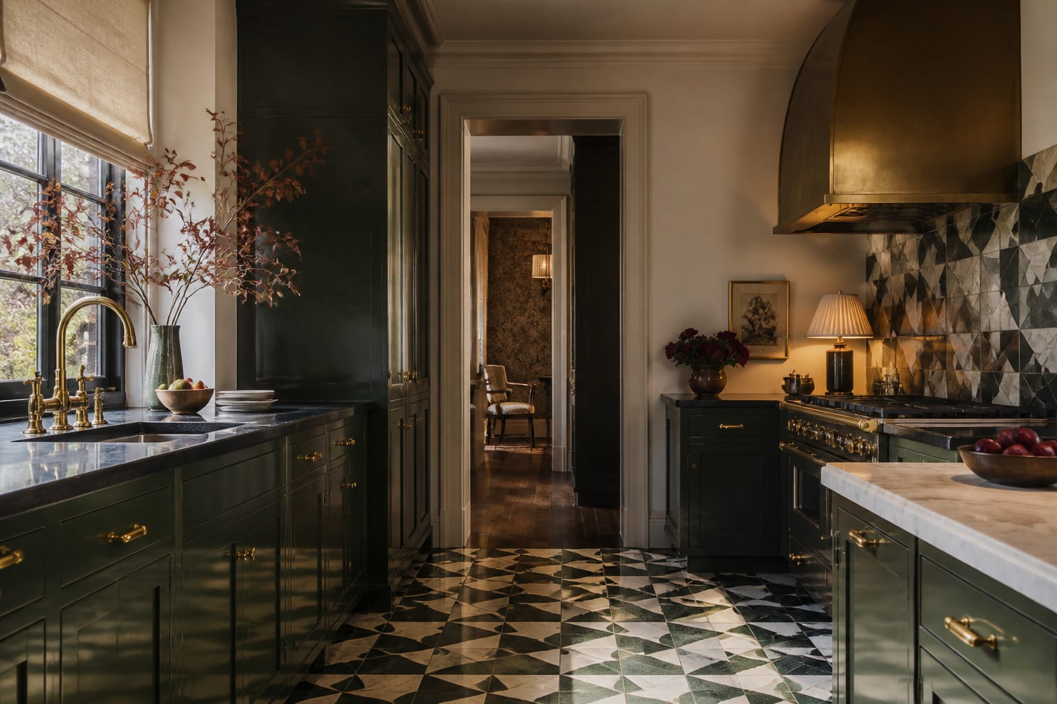 Editorial interior photograph showing an art deco kitchen with geometric tile, brass hardware, lacquered cabinetry, stone counters, and warm lighting.