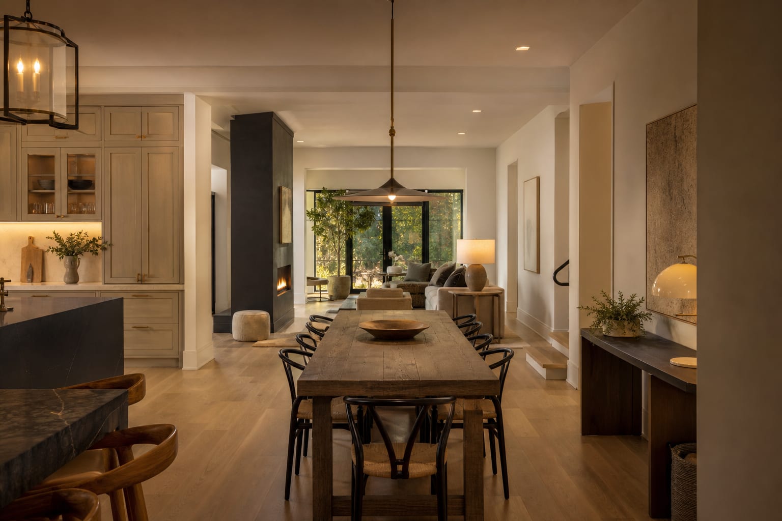 A slim dining table aligned with a clear walking lane through a bright dining room between kitchen and living space