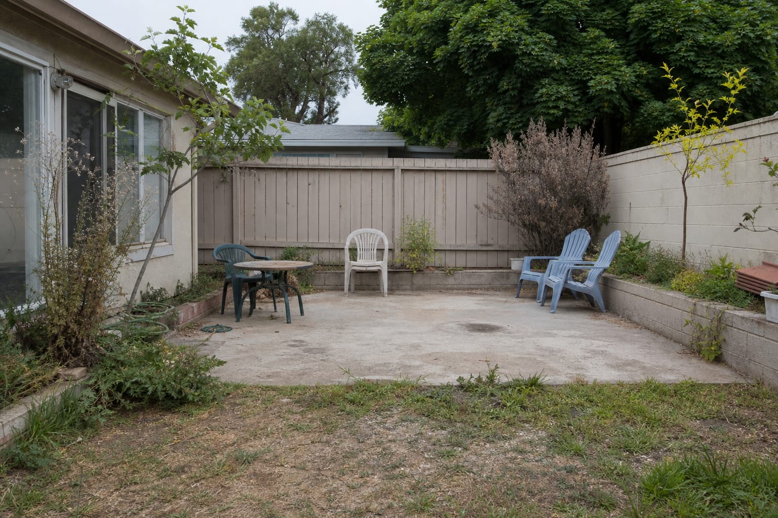 Patchy front lawn with exposed dry soil, scattered pots, narrow planting strips, and no shaded seating or clear garden path.