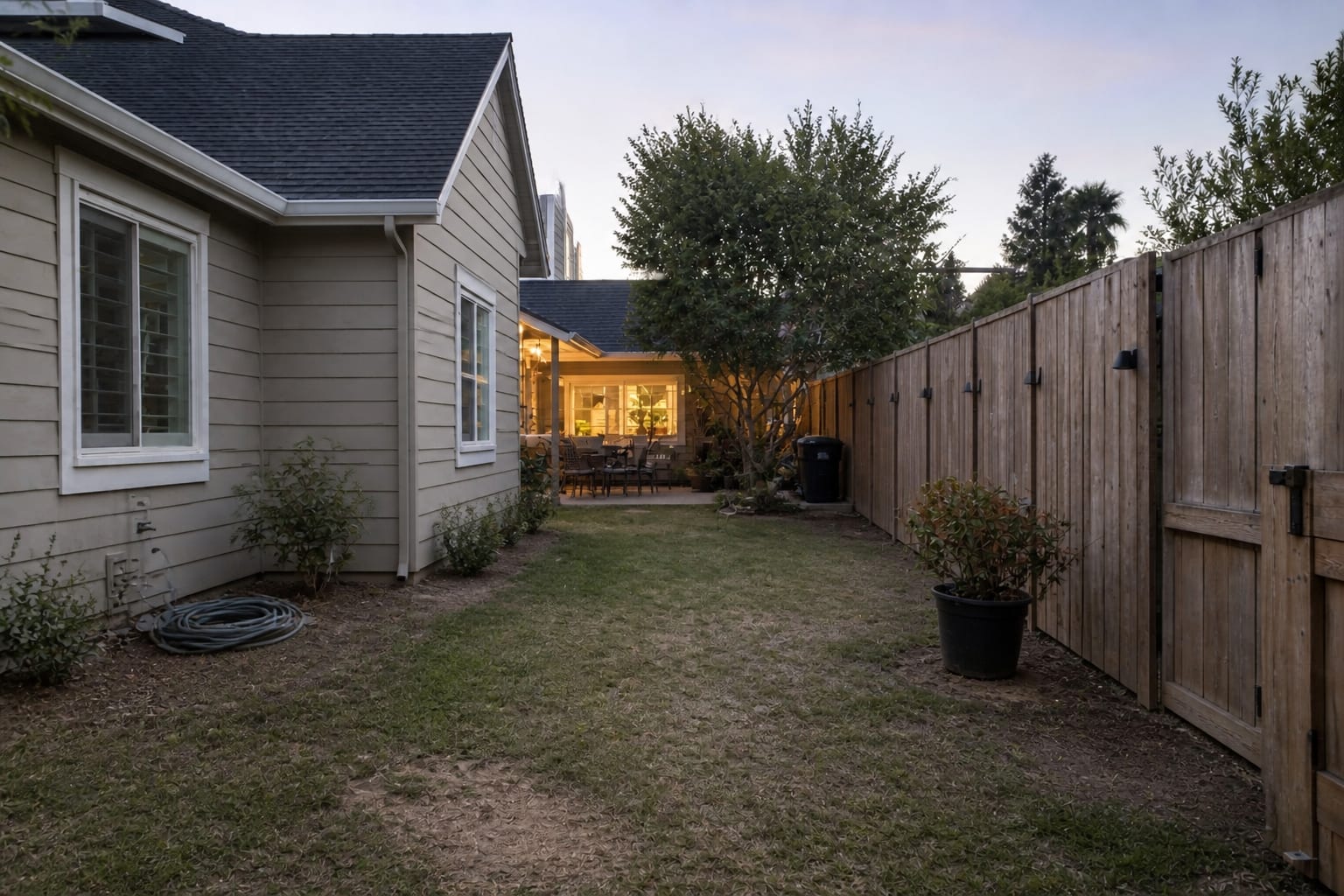 flat garden path with lawn edges, scattered pots, and no vertical structure marking the entrance