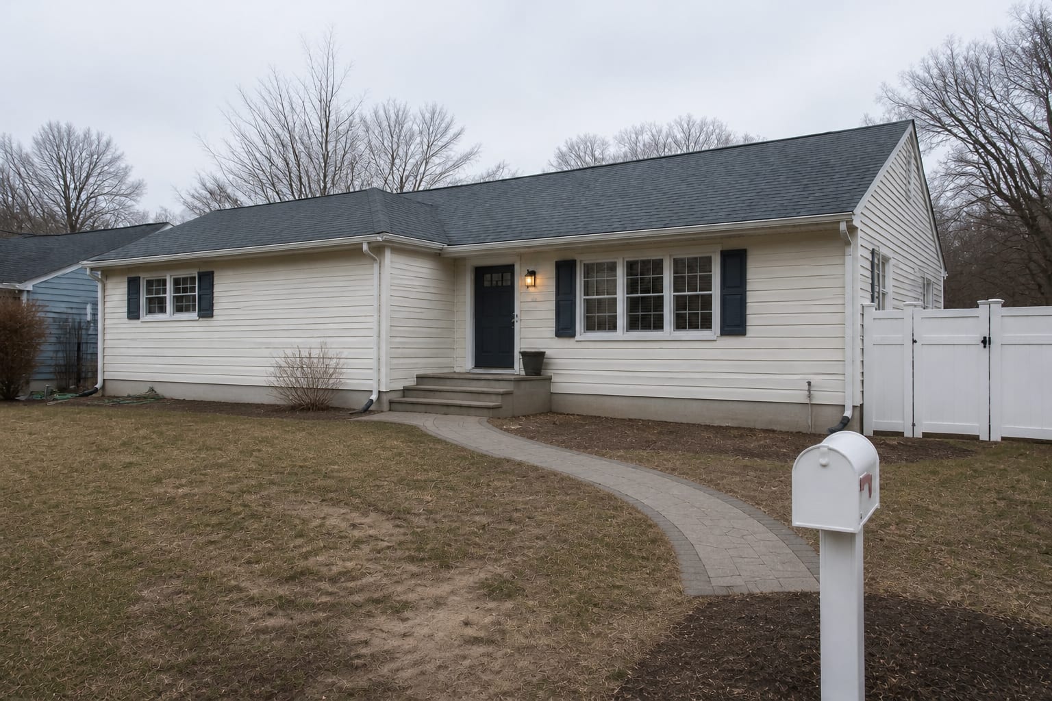 Bare front yard with patchy lawn and empty beds before landscaping