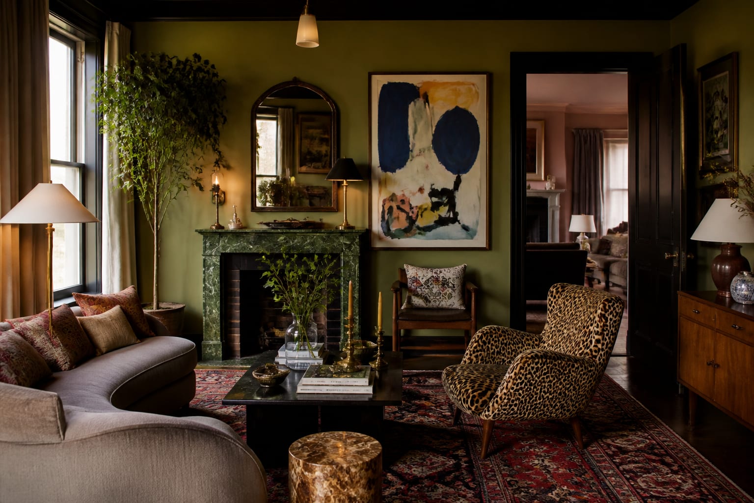 layered living room with bold art, patterned rug, vintage chairs, saturated color, and a curated mix of objects