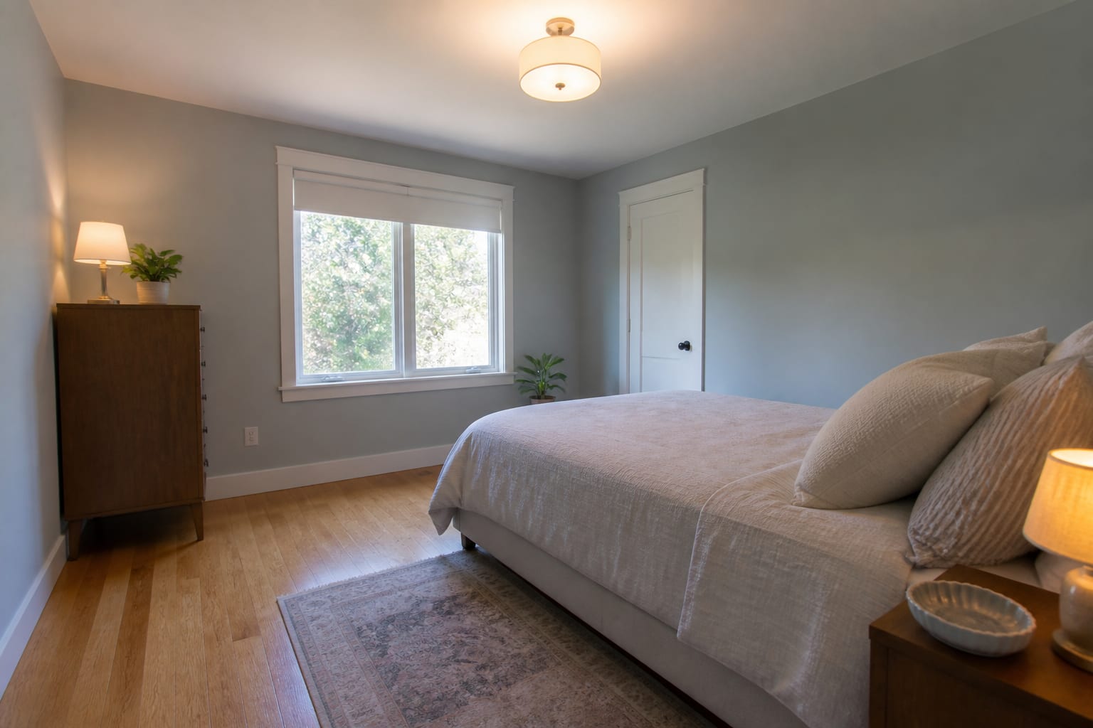 phone photo of a small bedroom from standing height showing bed, window, floor, and wall color before an AI redesign